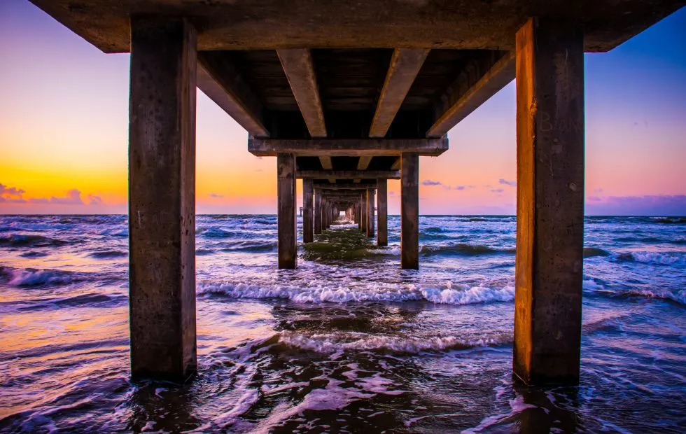 Deep perspective of the Port Aransas Pier out into the beach